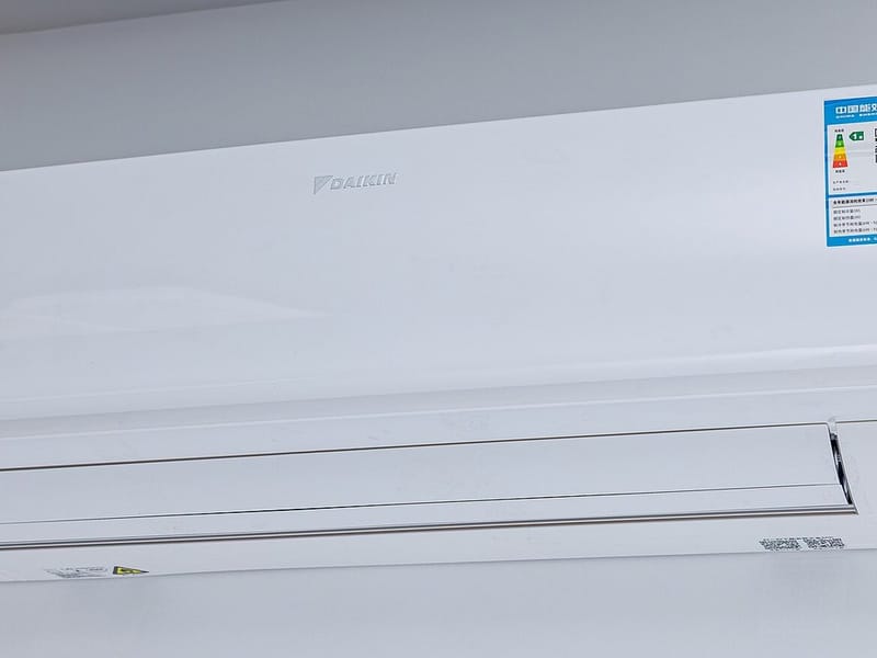 A ductless mini-split head on a bedroom wall